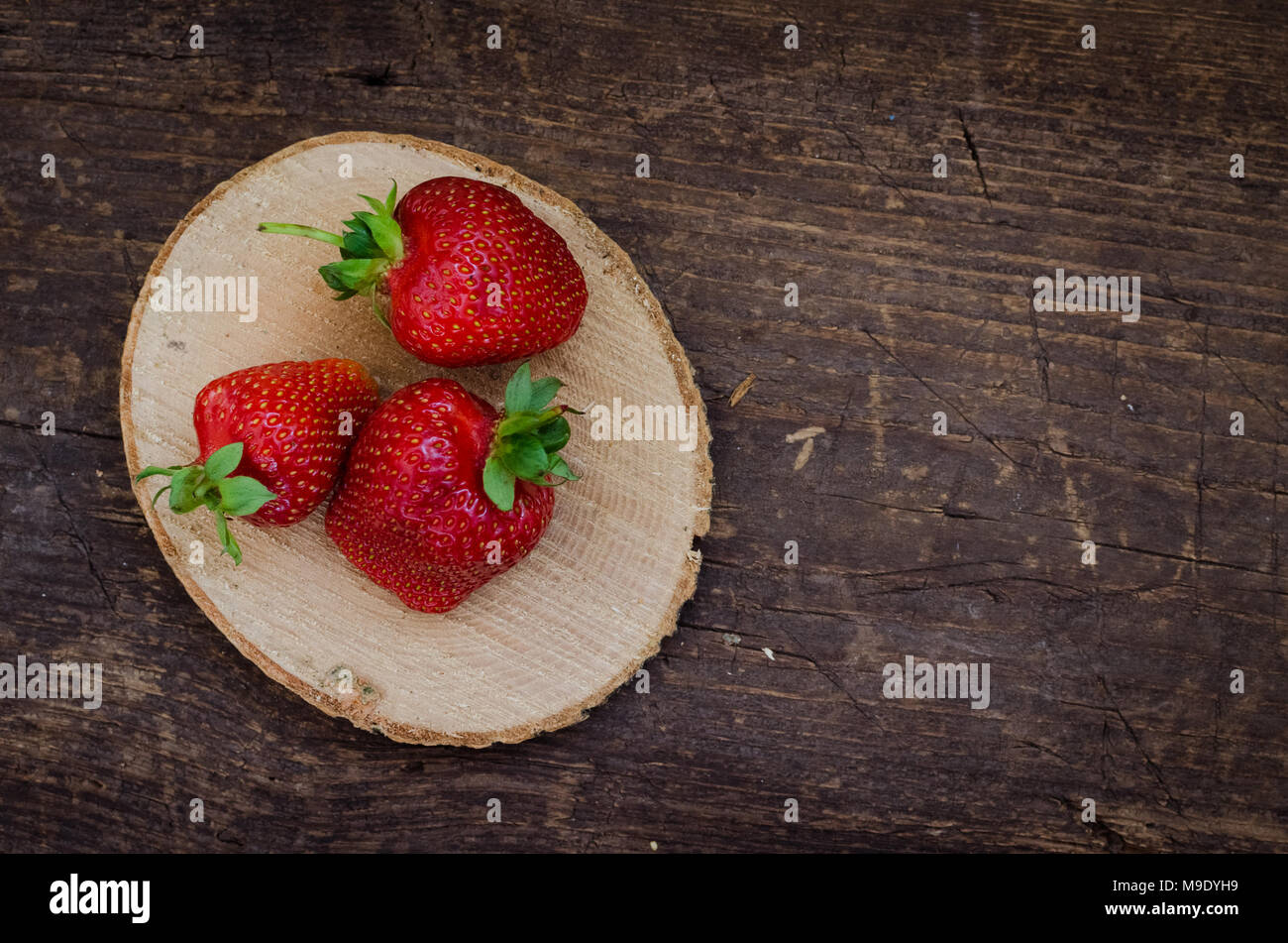 Red berry strawberry on old rustic wooden background. Background from ...