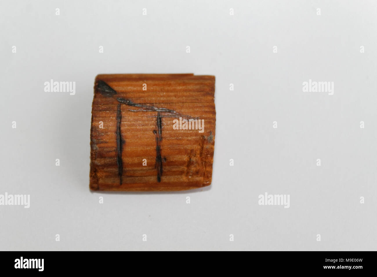 Wooden rune which means pear-tree, lie on a table on a white background Stock Photo