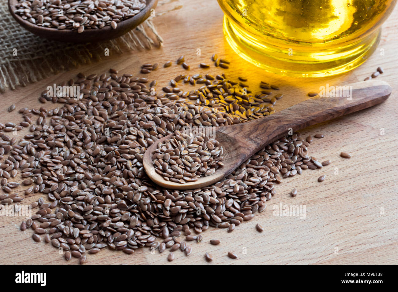 Flaxseed On A Wooden Spoon With Flaxseed Oil In The Background Stock Photo Alamy