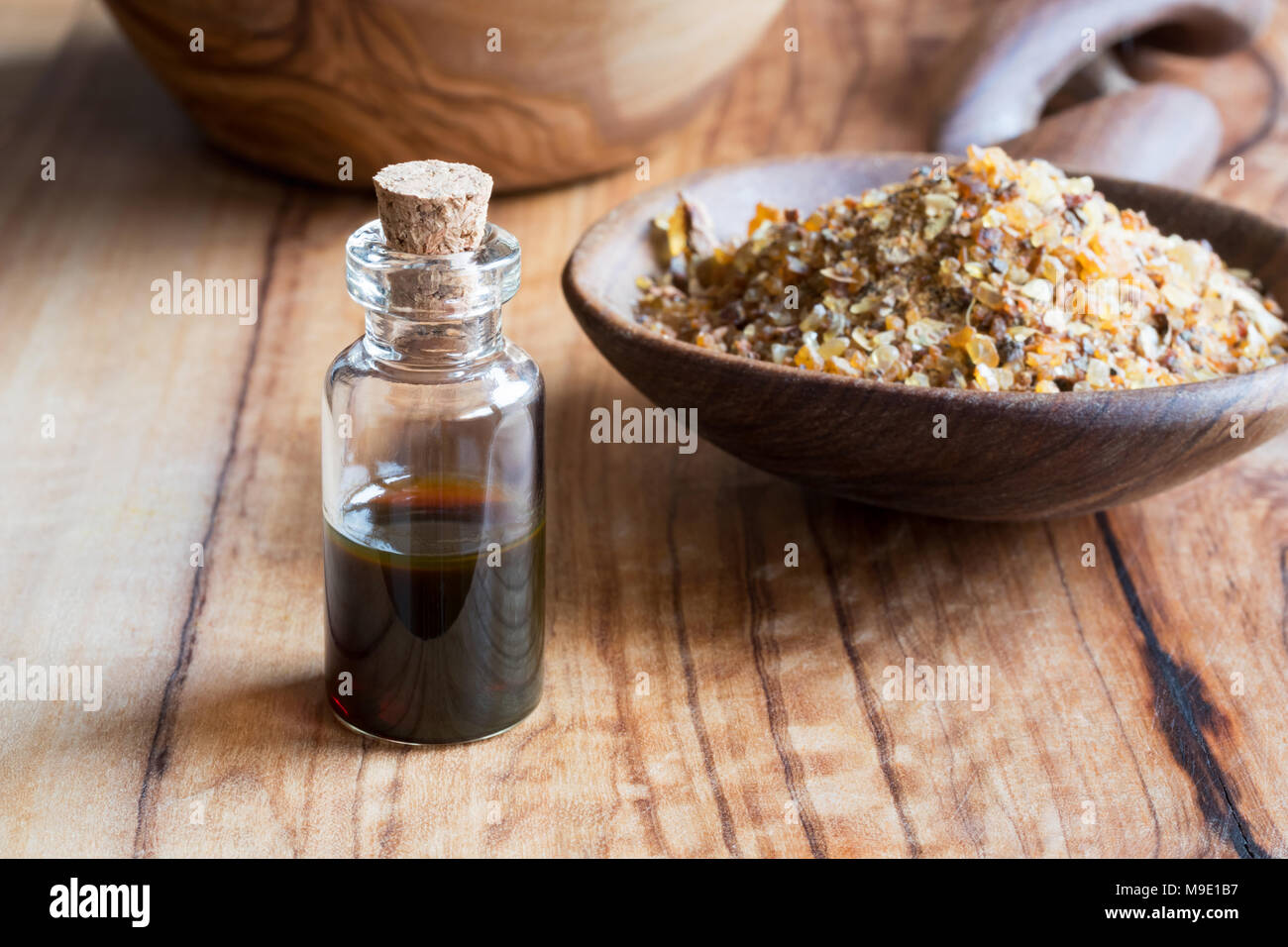 A bottle of myrrh essential oil with myrrh resin on a dark background Stock  Photo - Alamy