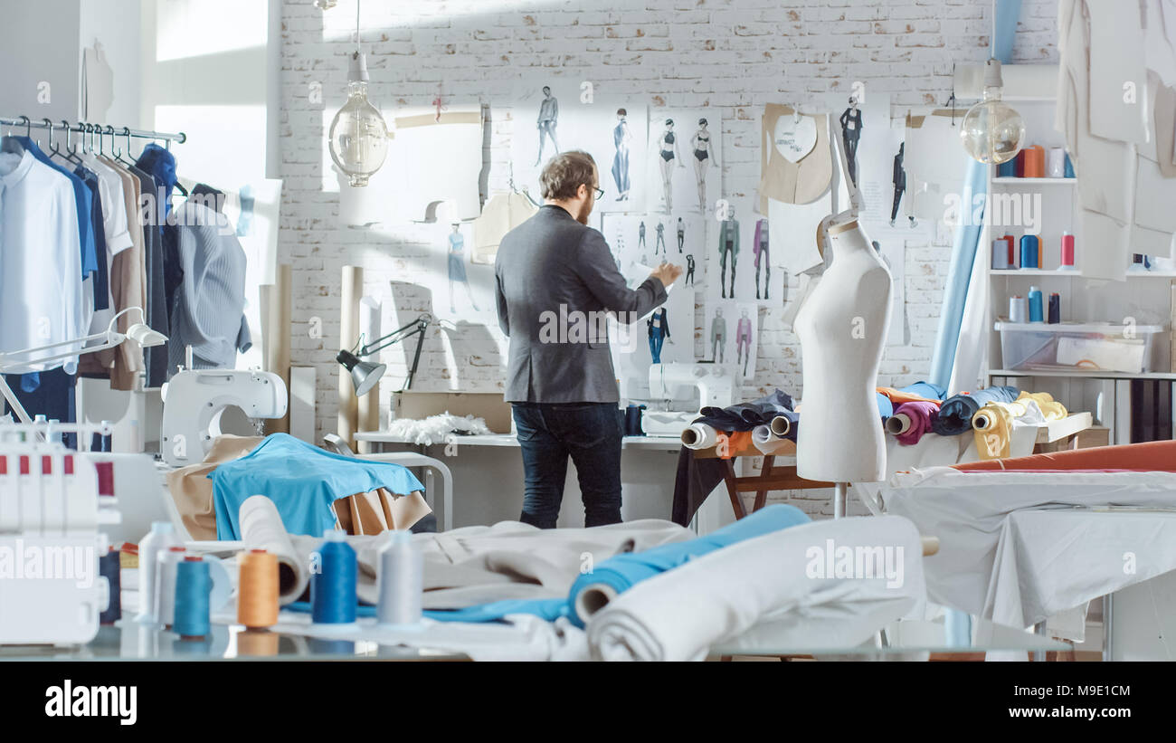 Male fashion, designer, Pins Clothing Sketches to the Wall. His Studio