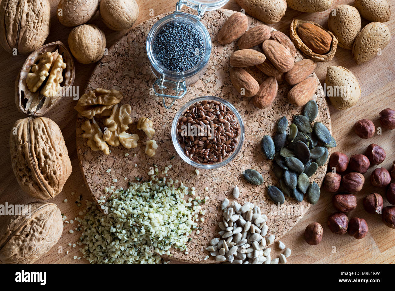 Nuts and seeds - walnuts, almonds, flax seeds, hazelnuts, hemp, pumpkin and sunflower seeds. Top view. Stock Photo