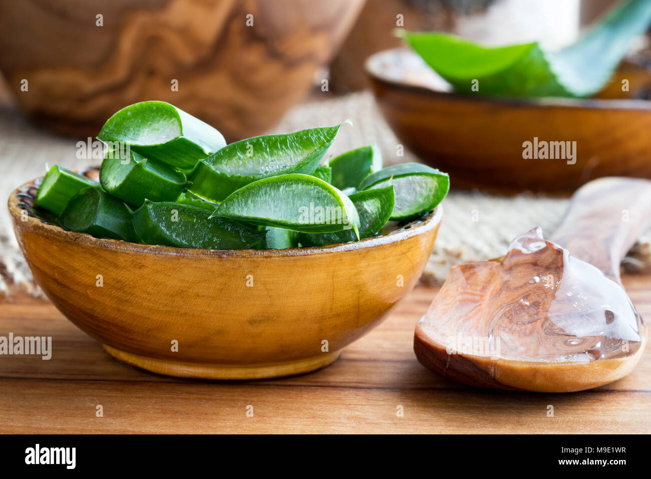 Aloe vera pieces in a wooden bowl with aloe vera gel on a spoon Stock Photo  - Alamy