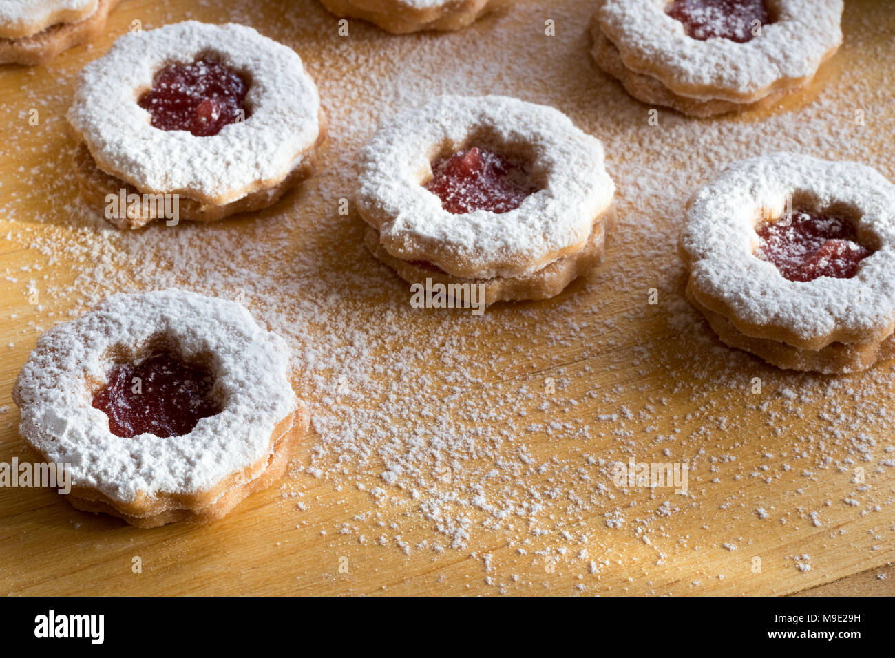 Traditional Linzer Christmas cookies with strawberry jam dusted with