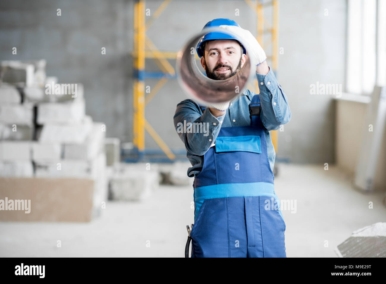Builder with ventilation pipe Stock Photo - Alamy