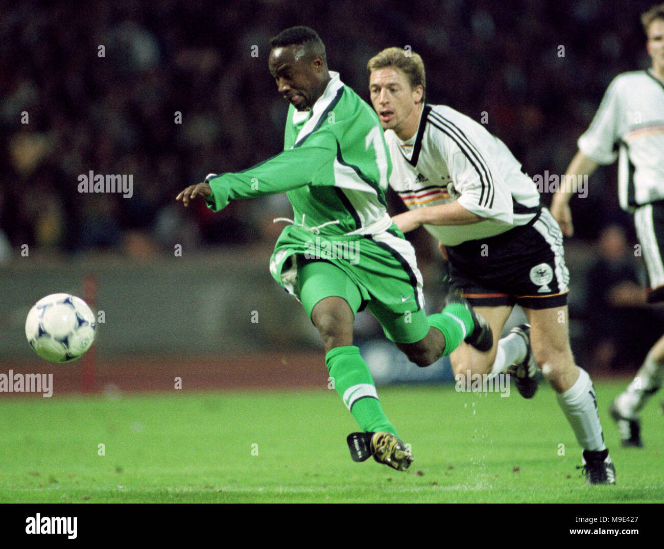 Mungersdorfer Stadion Cologne, Germany  22.4.1998, Football International Friendly, Germany vs Nigeria 1:0 ---- Tijani BABANGIDA (Nigeria), Steffen Freund Stock Photo