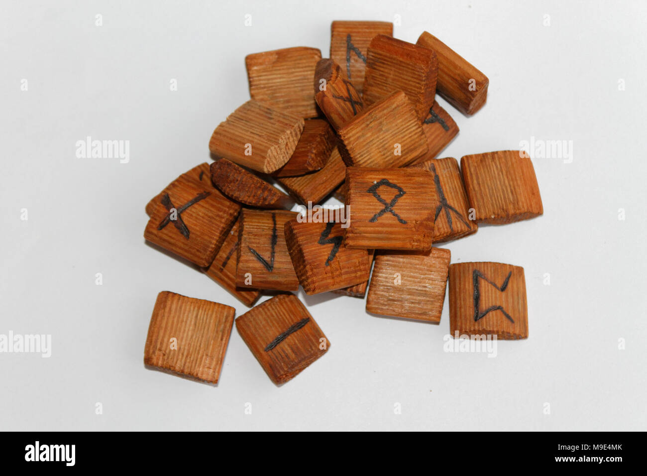 Wooden runes lie on a table on a white background Stock Photo