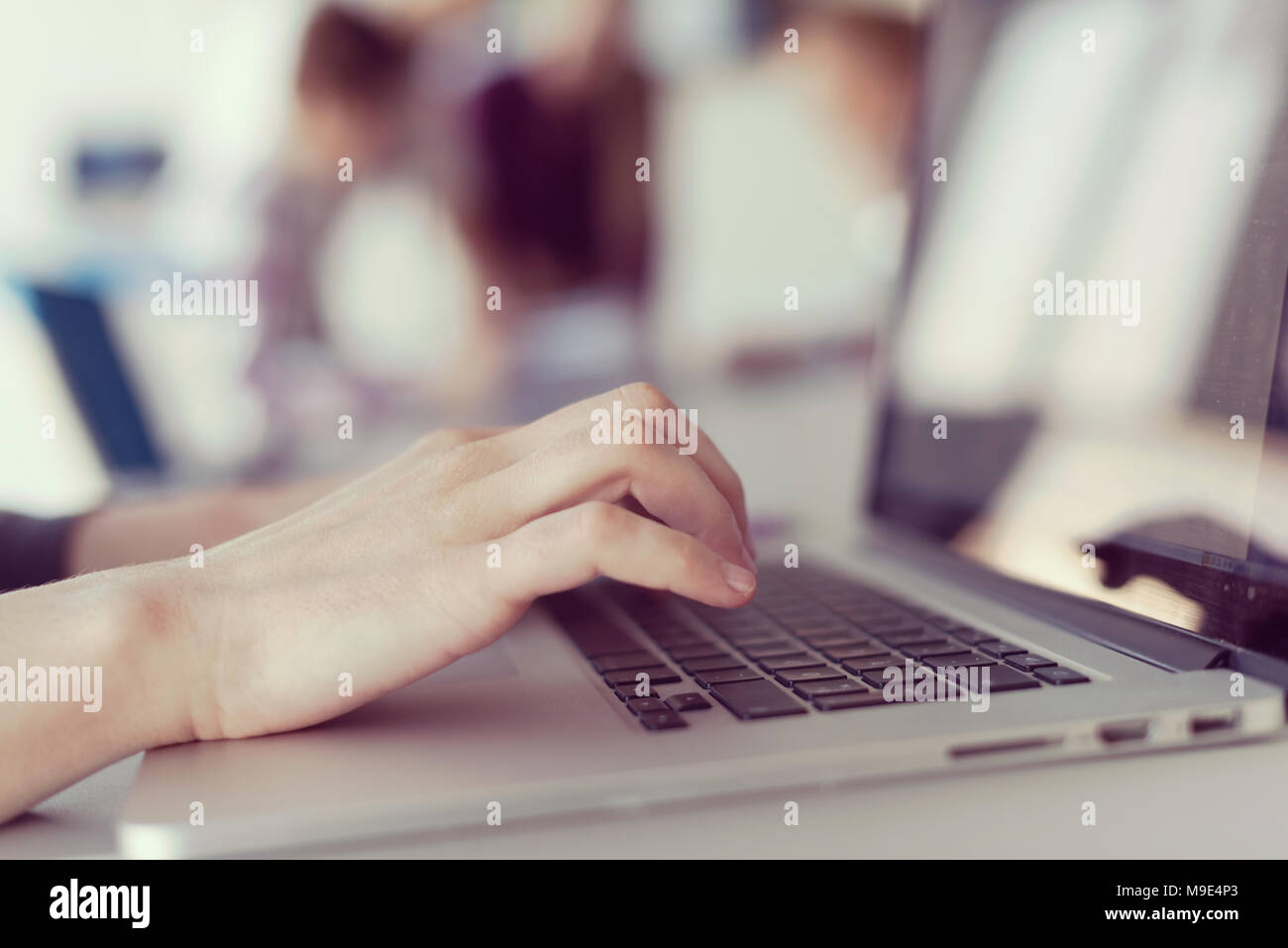 Computer Typing Group close up of business womans hand typing on laptop at modern startup ...