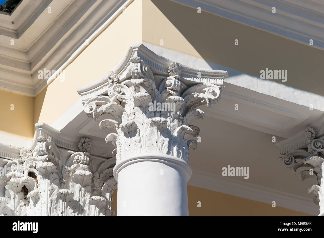 Corinthian capital of a vintage column, which supports a roof eave of a old stylish house Stock Photo