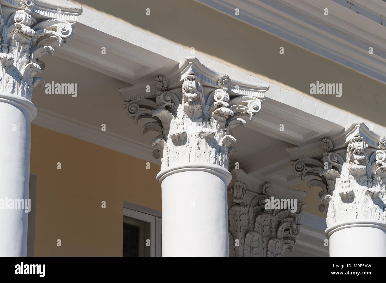 Corinthian capital of a vintage column, which supports a roof eave of a old stylish house Stock Photo