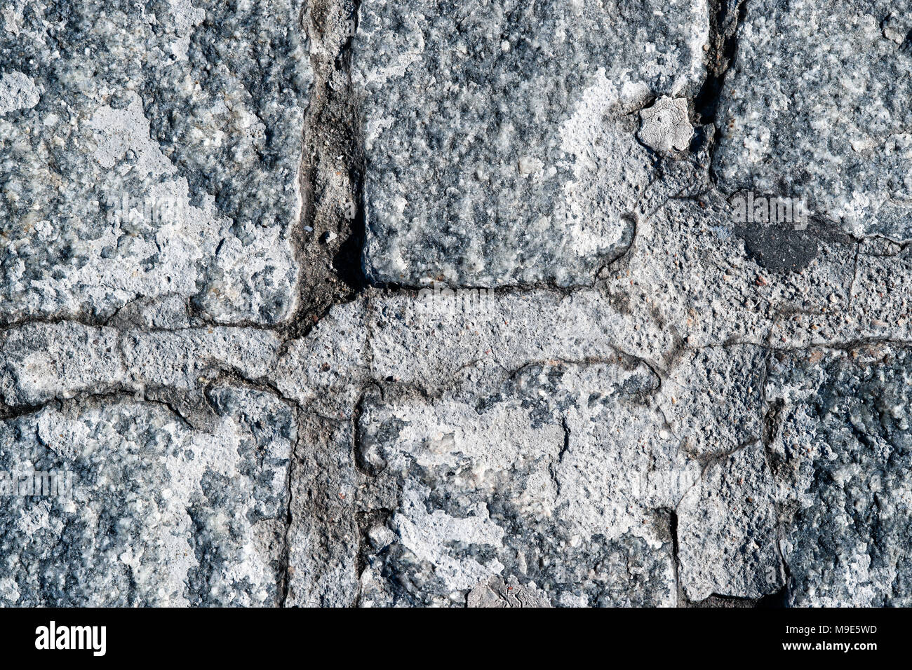 Texture of a hard rock stone paving blocks of grey and blue colors. Grunge rough surface Stock Photo