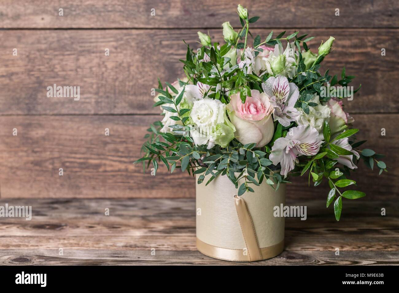 Wedding bouquet in a box on a wooden background Stock Photo