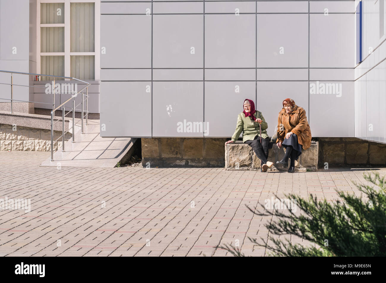 CHISINAU, MOLDOVA -27 APRIL, 2016: Two old ladies resting in the sun. Stock Photo