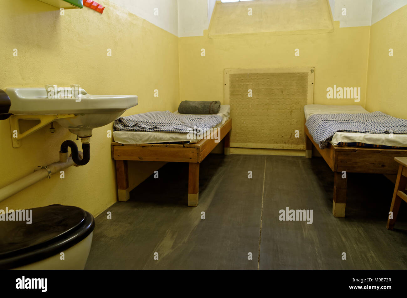 Leipzig, Germany - June 12, 2015. Jail cell with two bunk beds and sink are exposed in the Stasi Museum in Leipzig, Germany Stock Photo