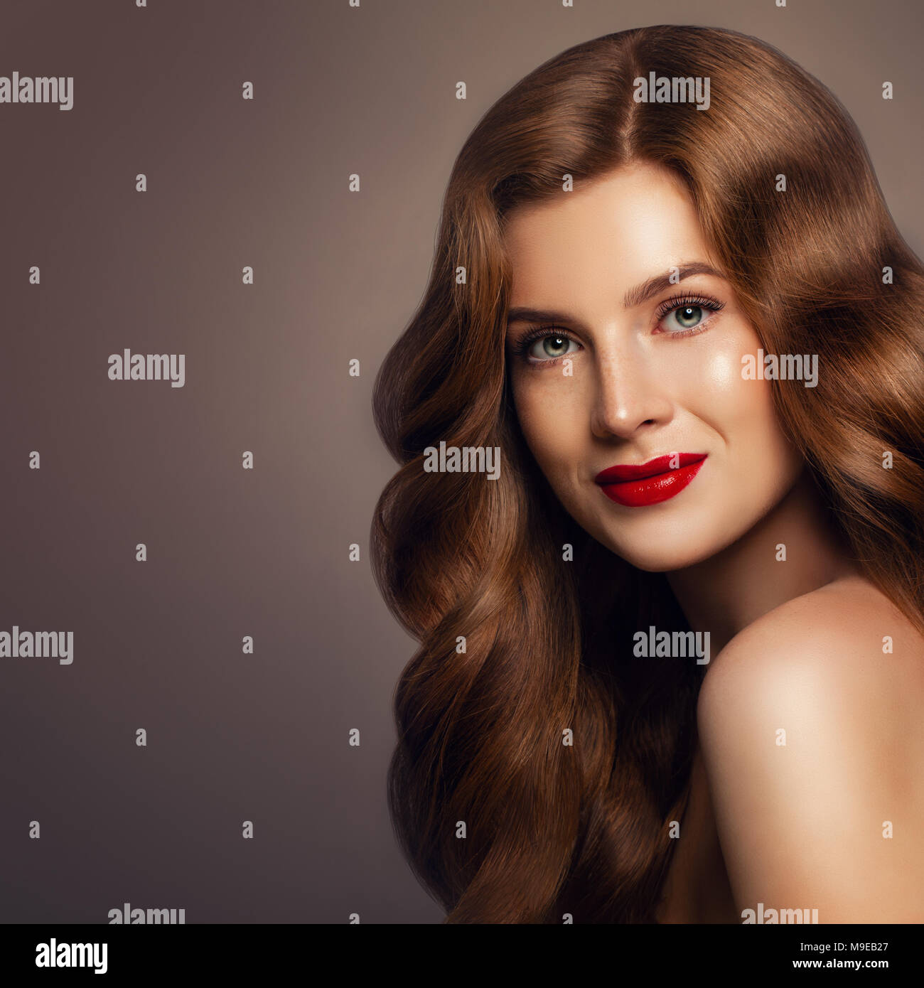 Haircare Concept. Beautiful Woman with Long Healthy Wavy Hairstyle. Girl with Colored Hair, Portrait Stock Photo