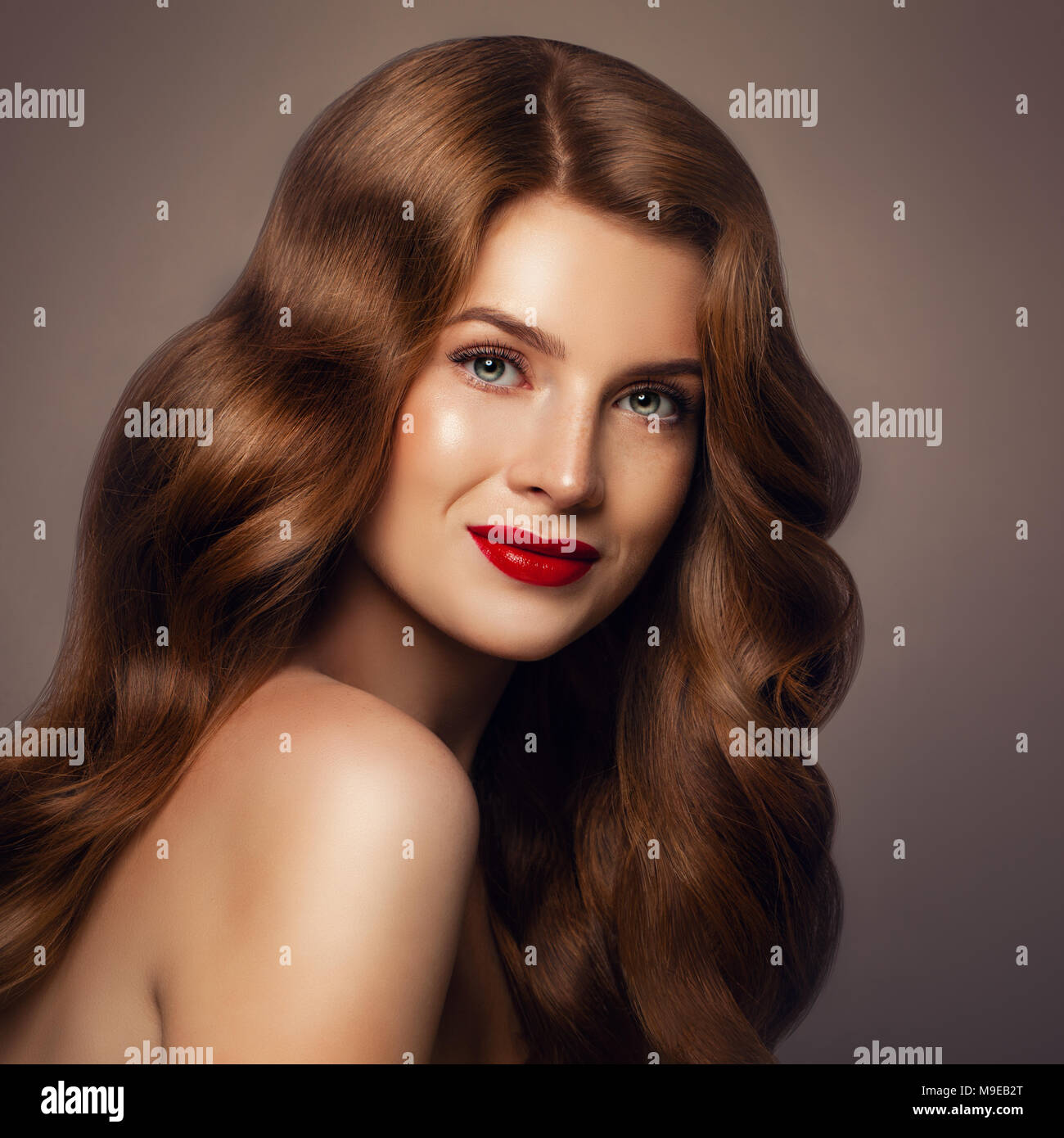 Beauty Portrait of Redhead Fashion Model Woman with Long Hair. Stylish Lady with Perfect Hairstyle Stock Photo