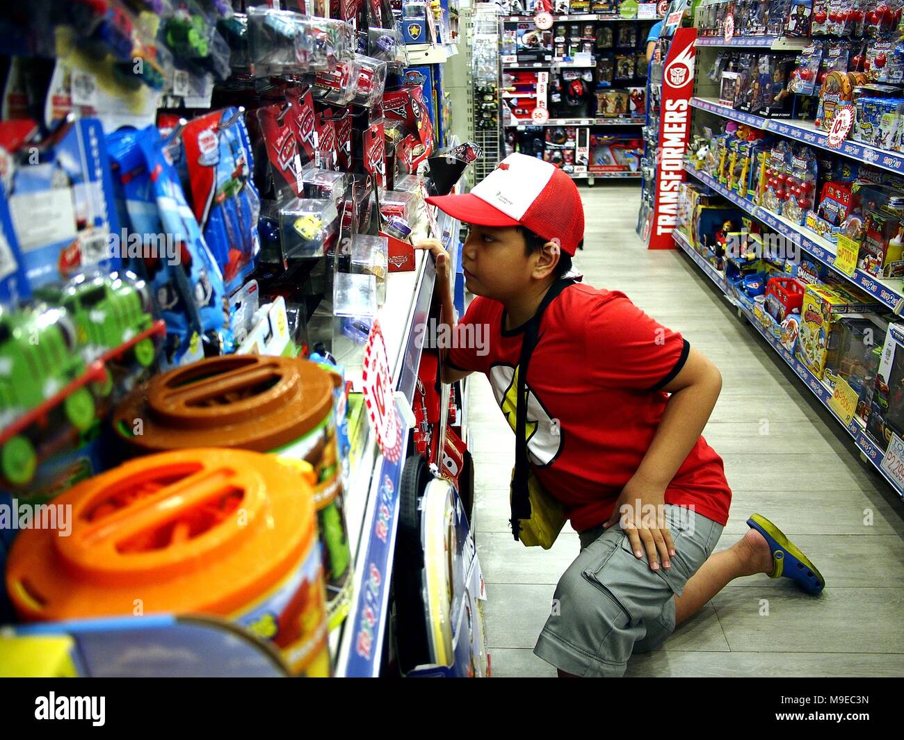 Boy looks at toys hires stock photography and images Alamy