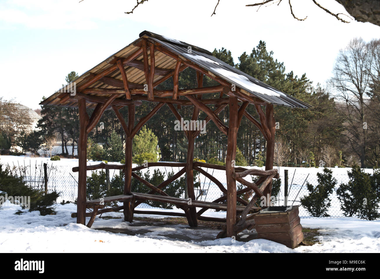 Empty arbor among the winter forest. Pavilion for a picnic in the winter forest. Stock Photo