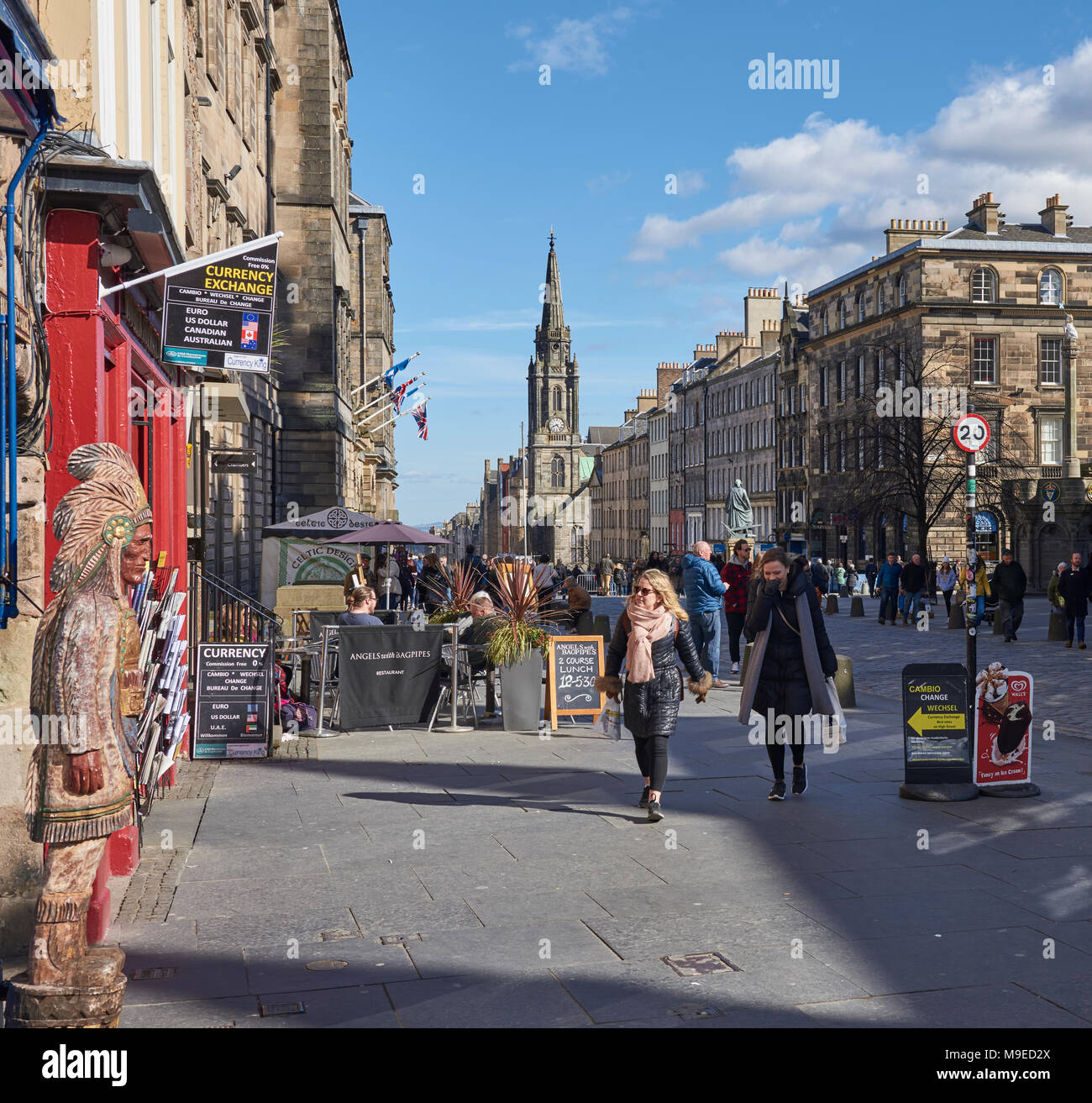Shoppers and Other People enjoying the Brisk Spring Sunshine on the Royal Mile in Edinburgh City, in Scotland. Stock Photo