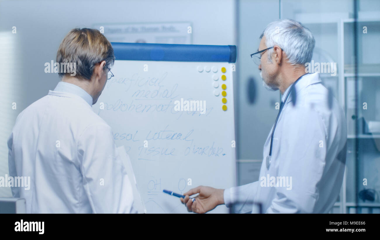 Two Specialist Doctors Discussing Health Issues and Medical Drug Trial