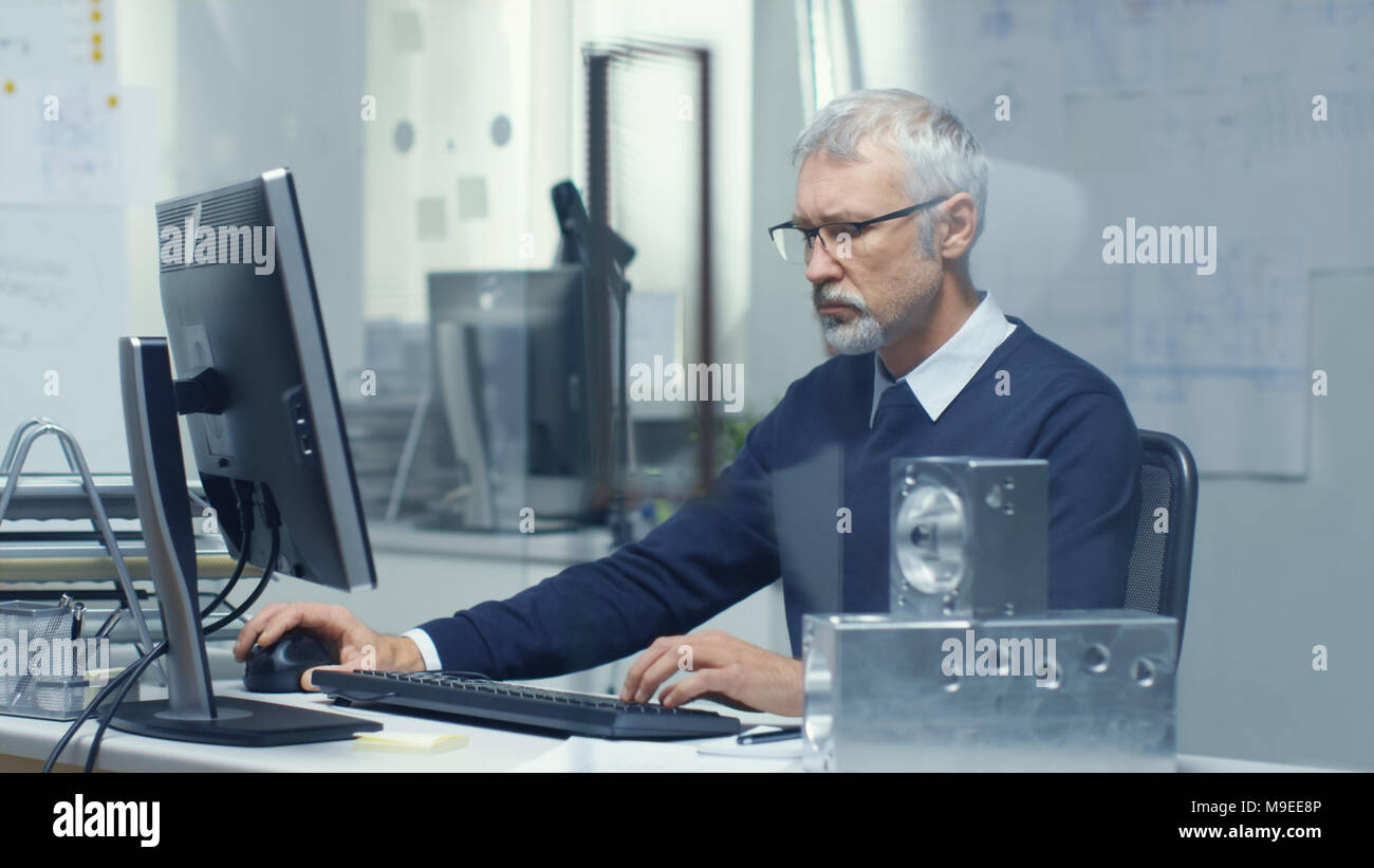 Engineering Bureau. Chief Engineer Working at His Desk, Some Technical