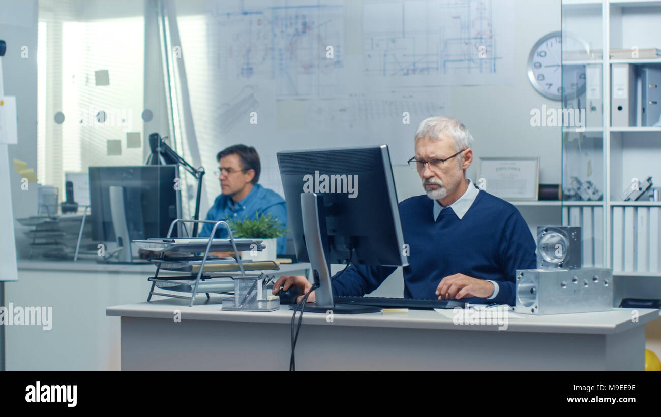 Engineering Bureau. Engineer Working at His Desk, Some Technical