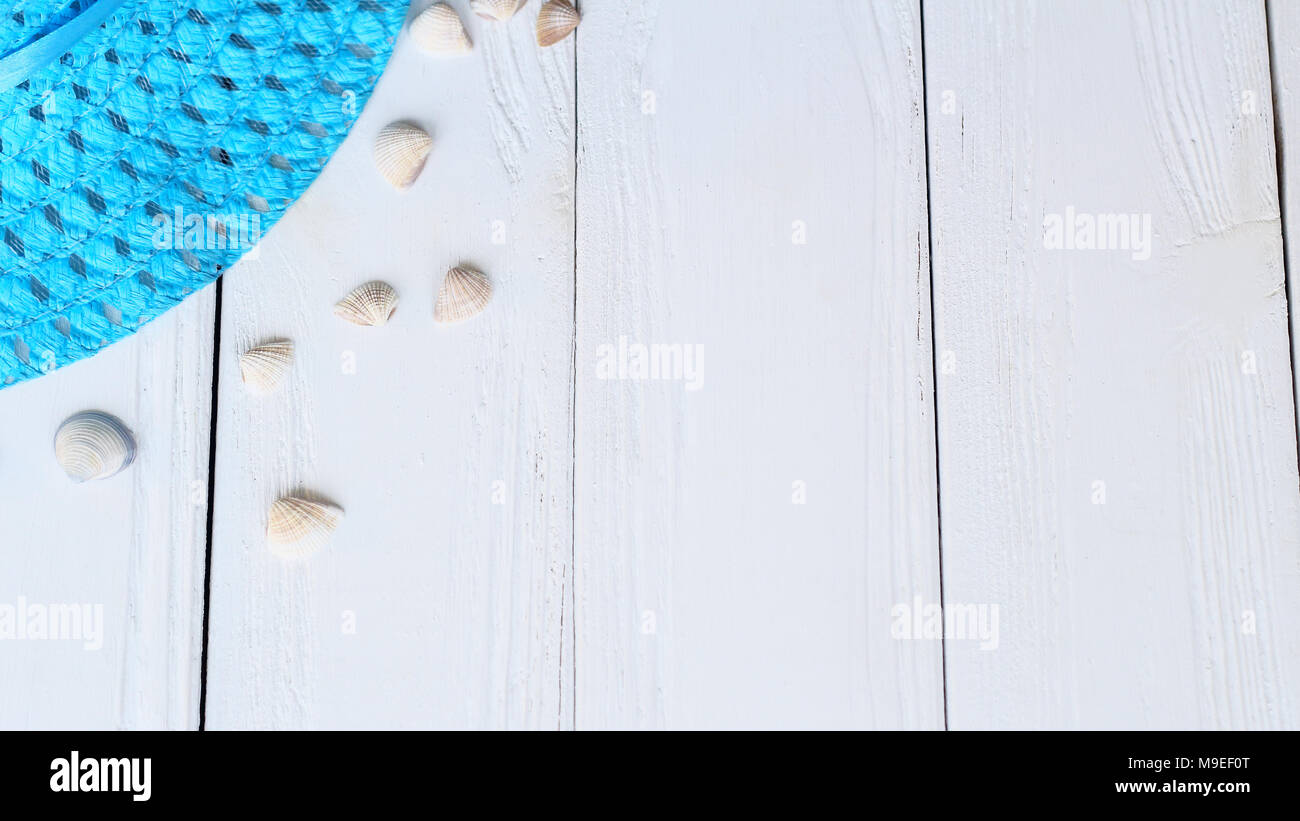 straw hat and seashells on wooden background.photo with place for text ...