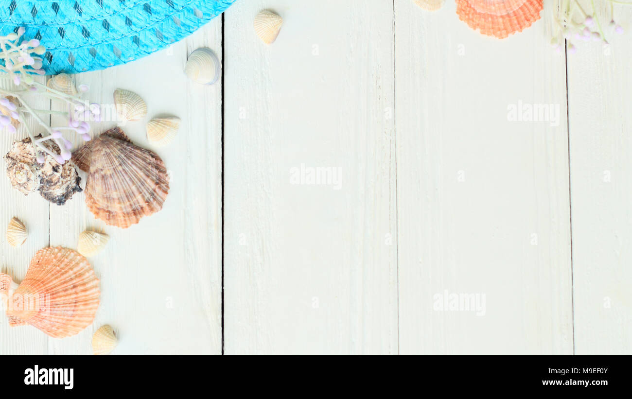 beach straw hat and seashells on a wooden background.photo with place ...