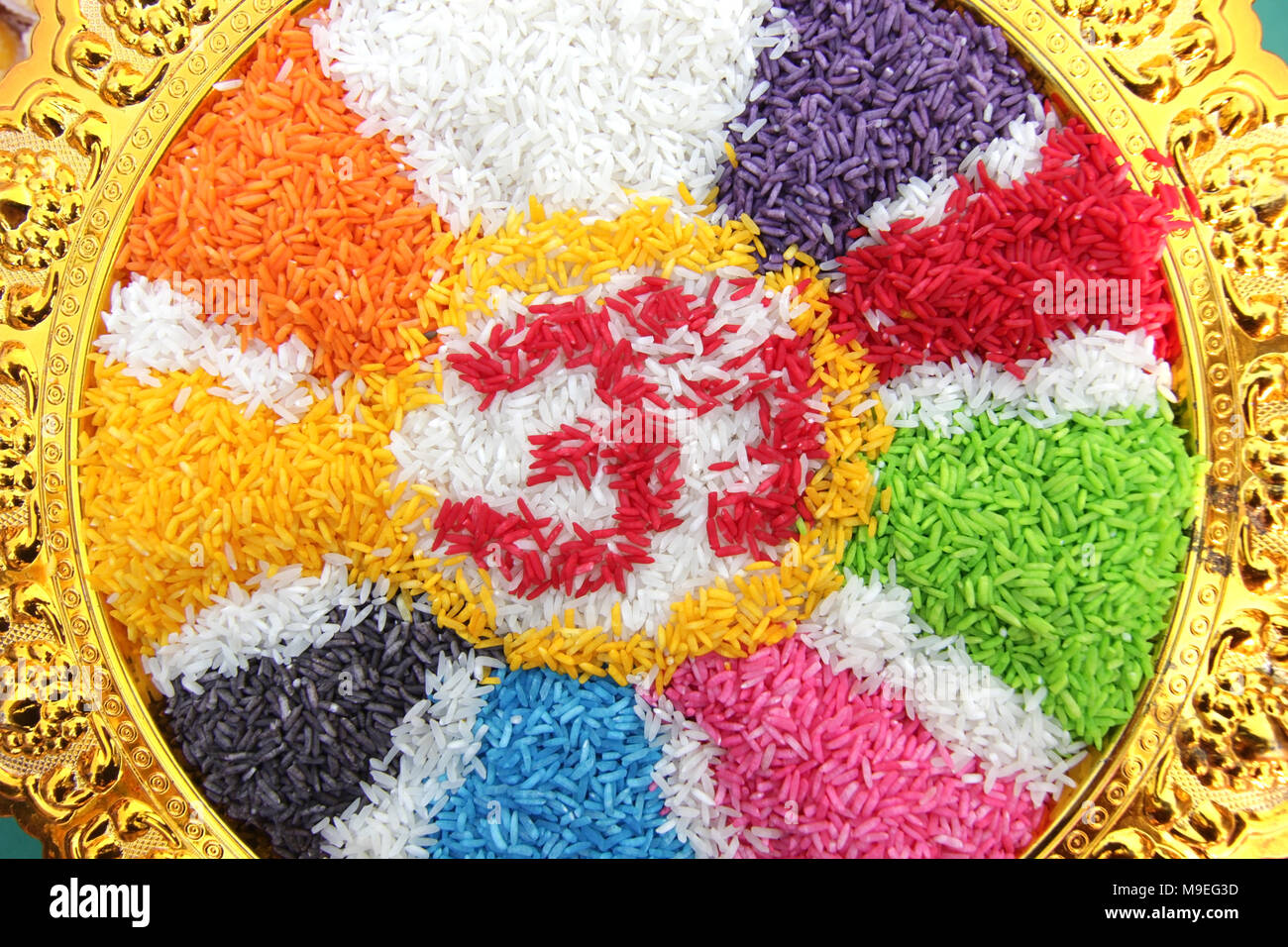 colorful hindu aum om symbol made from rice Stock Photo