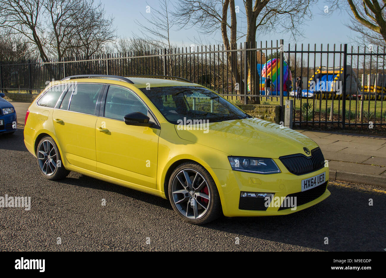 2014 yellow Škoda Octavia VRS TDI CR at Southport, Merseyside, .  Cars and tourists arrive in the coastal resort on a warm spring day. Cars are bumper to bumper on the seafront esplanade car enthusiasts take advantage of warm weather for a motoring day out. Stock Photo