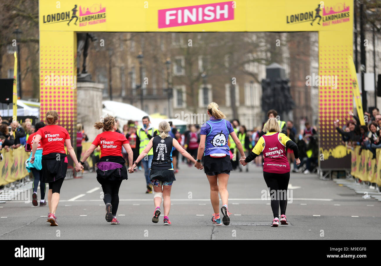 Runners hold hands on the way to the finish line of the 2018 London Landmarks Half Marathon. PRESS ASSOCIATION Photo. Picture date: Sunday March 25, 2018. Photo credit should read: Steven Paston/PA Wire Stock Photo