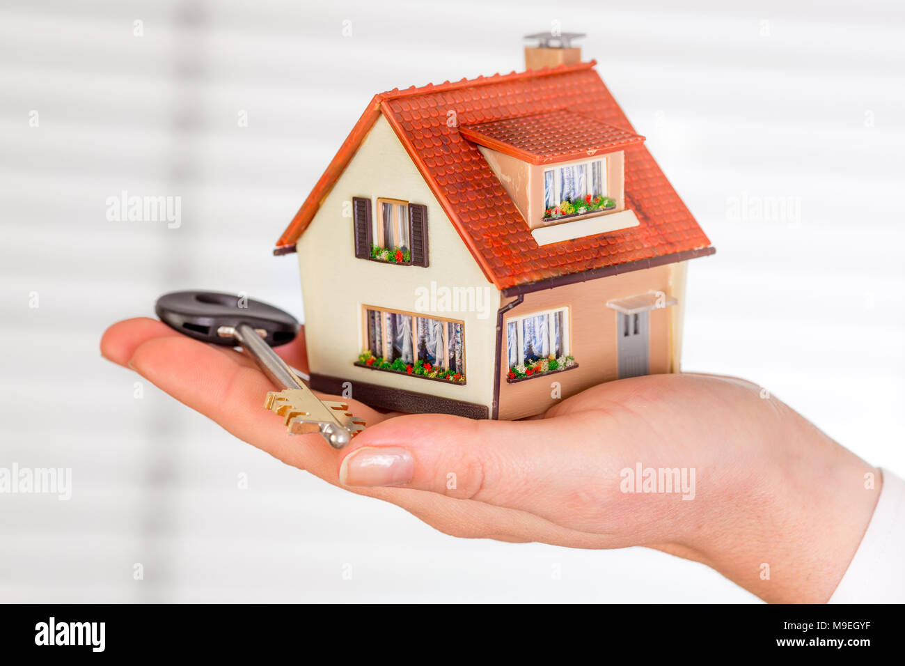 House an key in human hands on a white background Stock Photo - Alamy