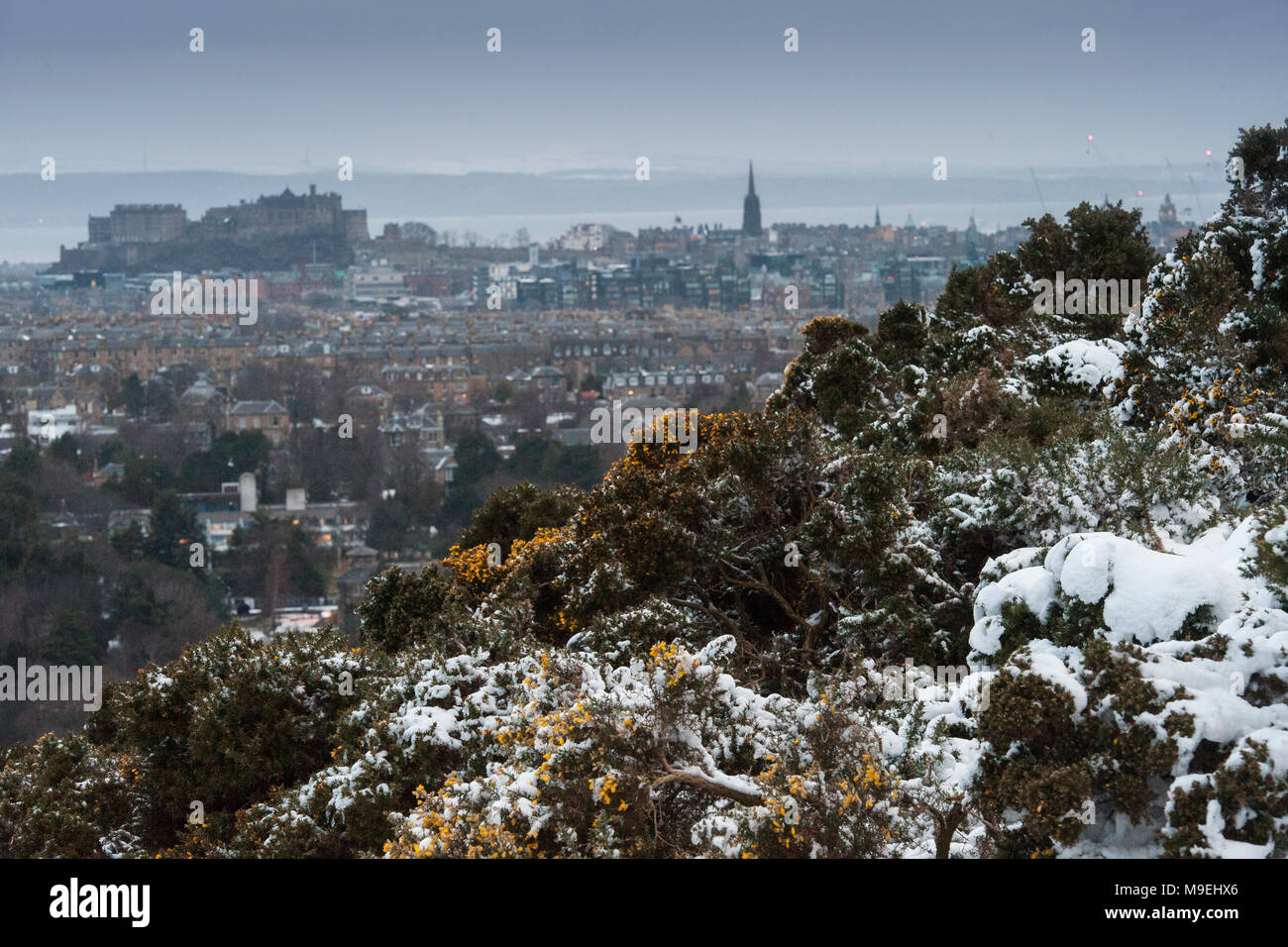 A view from high above Edinburgh in half light with Edinburgh Castle and King Arthur's Seat in the background Stock Photo