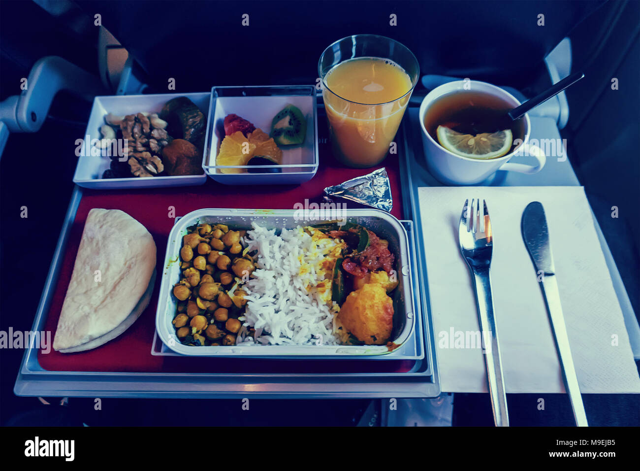 First Class Travel. a large set of meals provided by the airline for long-distance passengers during the flight. Stock Photo
