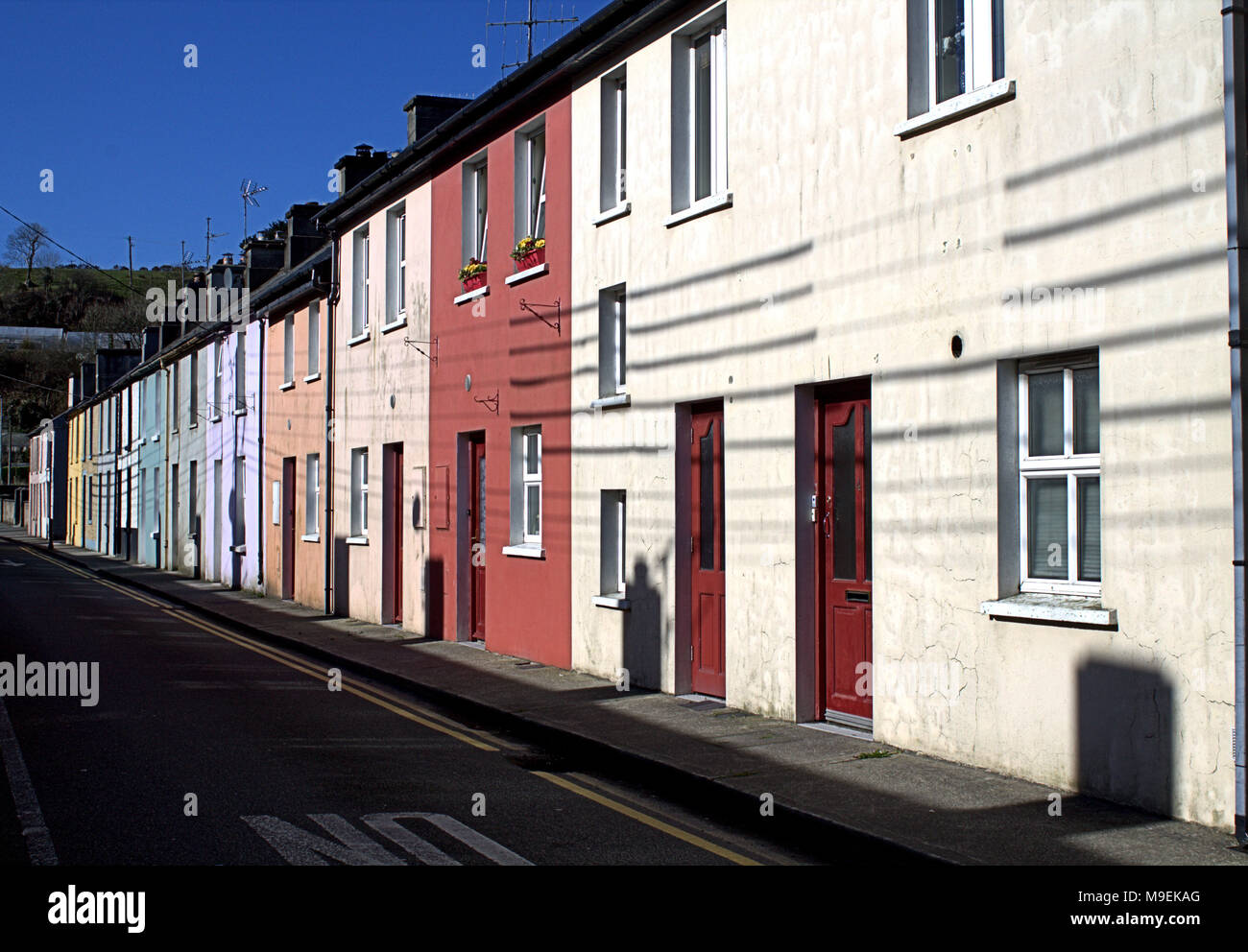 brightly coloured terraced houses in skibbereen, ireland a popular holiday destination and tourist town in west cork, ireland Stock Photo