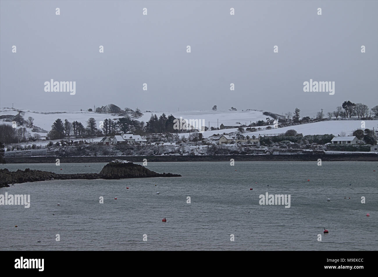 view across castlehaven harbour after winter snow storm. Stock Photo