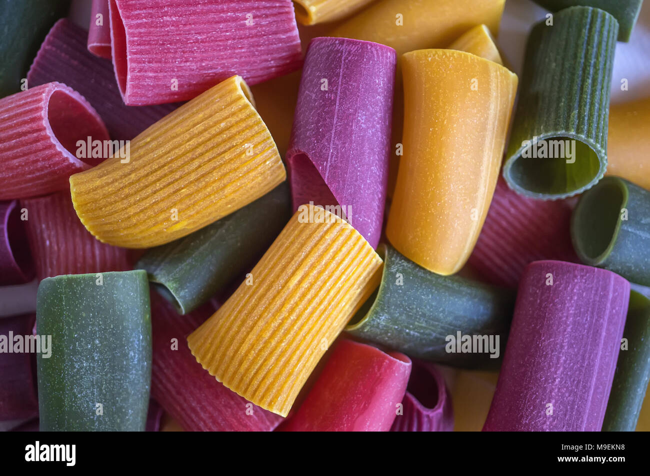 Mixed selection of dried pasta on wooden background. Macaroni scattered on a glass jar. Background. Close up. Stock Photo