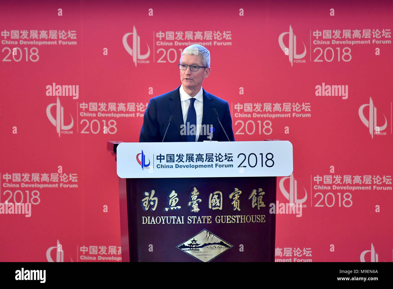 Beijing, China. 25th Mar, 2018. Apple CEO Tim Cook delivers a speech at the opening ceremony of the China Development Forum (CDF) 2018 at the Diaoyutai State Guesthouse in Beijing, capital of China, March 25, 2018. Credit: Li Xin/Xinhua/Alamy Live News Stock Photo