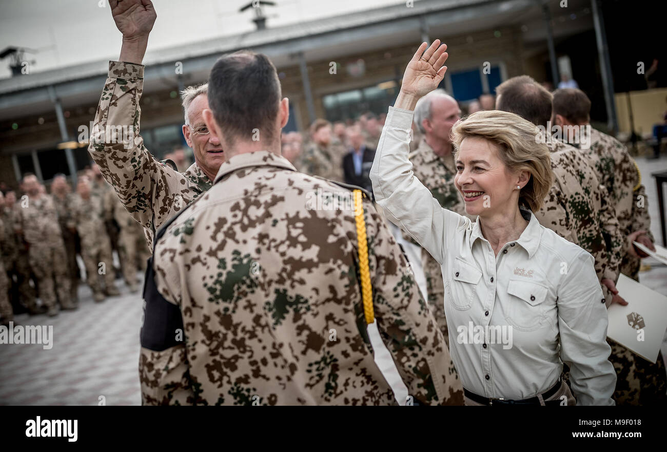 Mazar-i-Sharif, Afghanistan, 25 Mar 2018.  German Defence Minister Ursula von der Leyen of the Christian Democratic Union (CDU) congratulates General Wolf-Juergen Stahl (l, half-hidden) on his promotion. Traditionally, promotions are celebrated with a vigorous tap on the shoulder. Photo: Michael Kappeler/dpa Pool/dpa Stock Photo