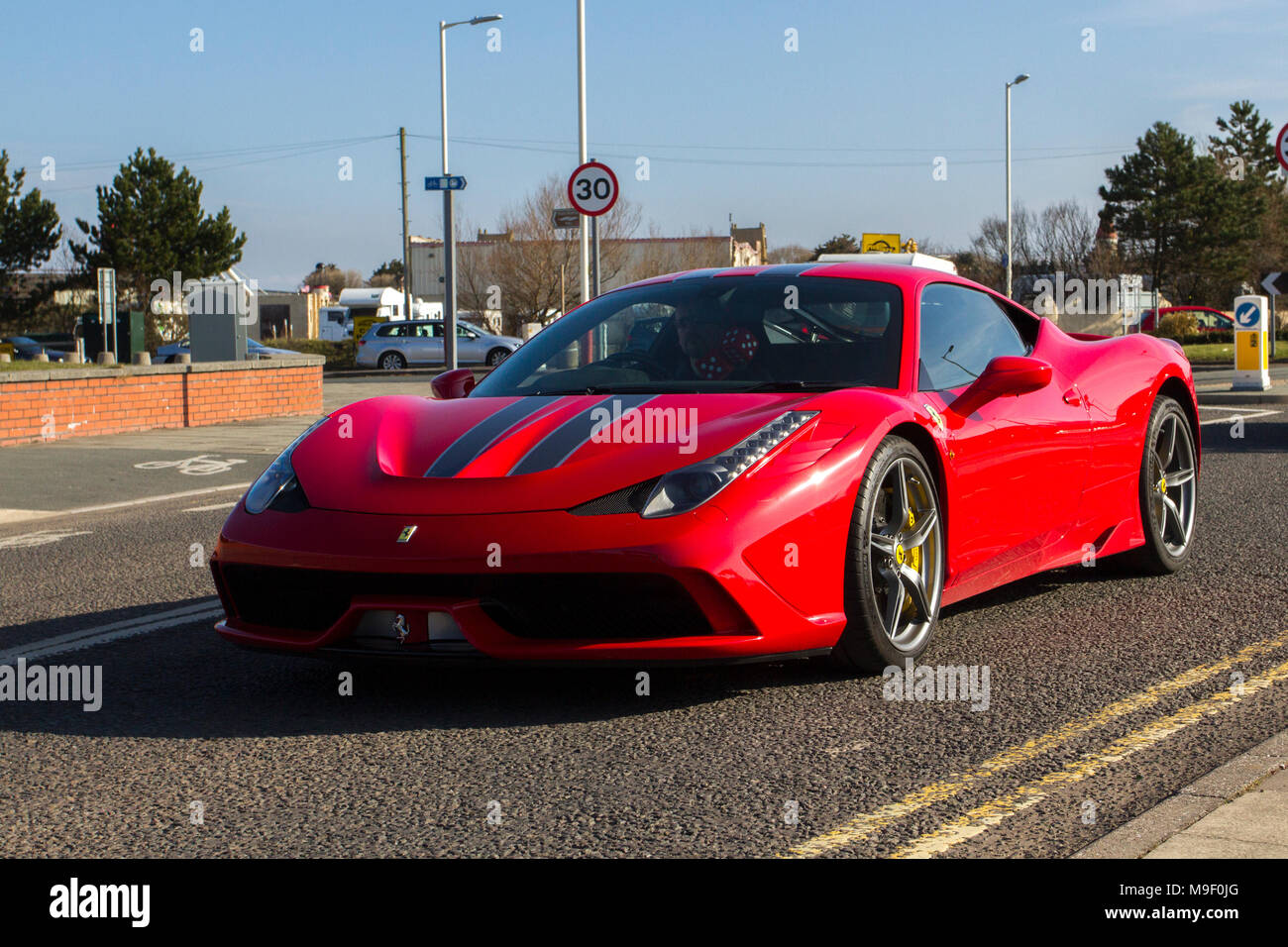 2015 red Ferrari 458 Speciale AB S-A 4497cc petrol coupe at the North-West Supercar event as cars and tourists arrive in the coastal resort of Southport. SuperCars are bumper to bumper on the seafront esplanade as classic & sports car enthusiasts enjoy a motoring day out. Stock Photo