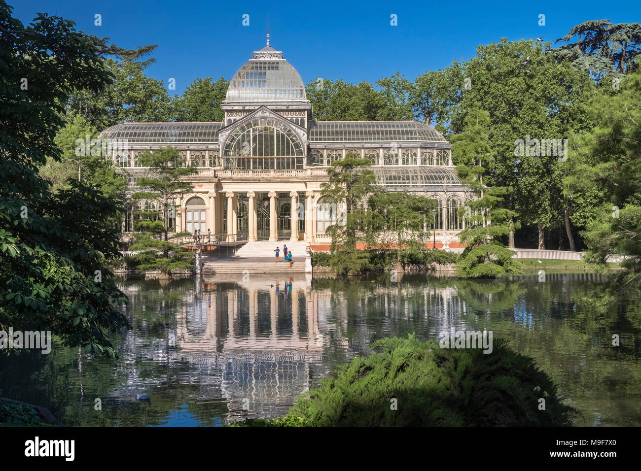 Palacio de Cristal, a glass and metal structure, located in popular attraction Buen Retiro Park, Madrid, Spain Stock Photo
