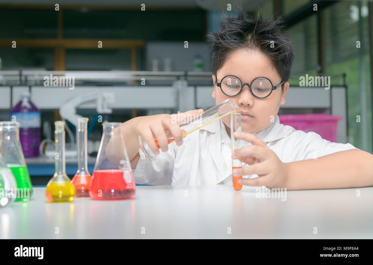 student asian boy is making science experiments education in laboratory