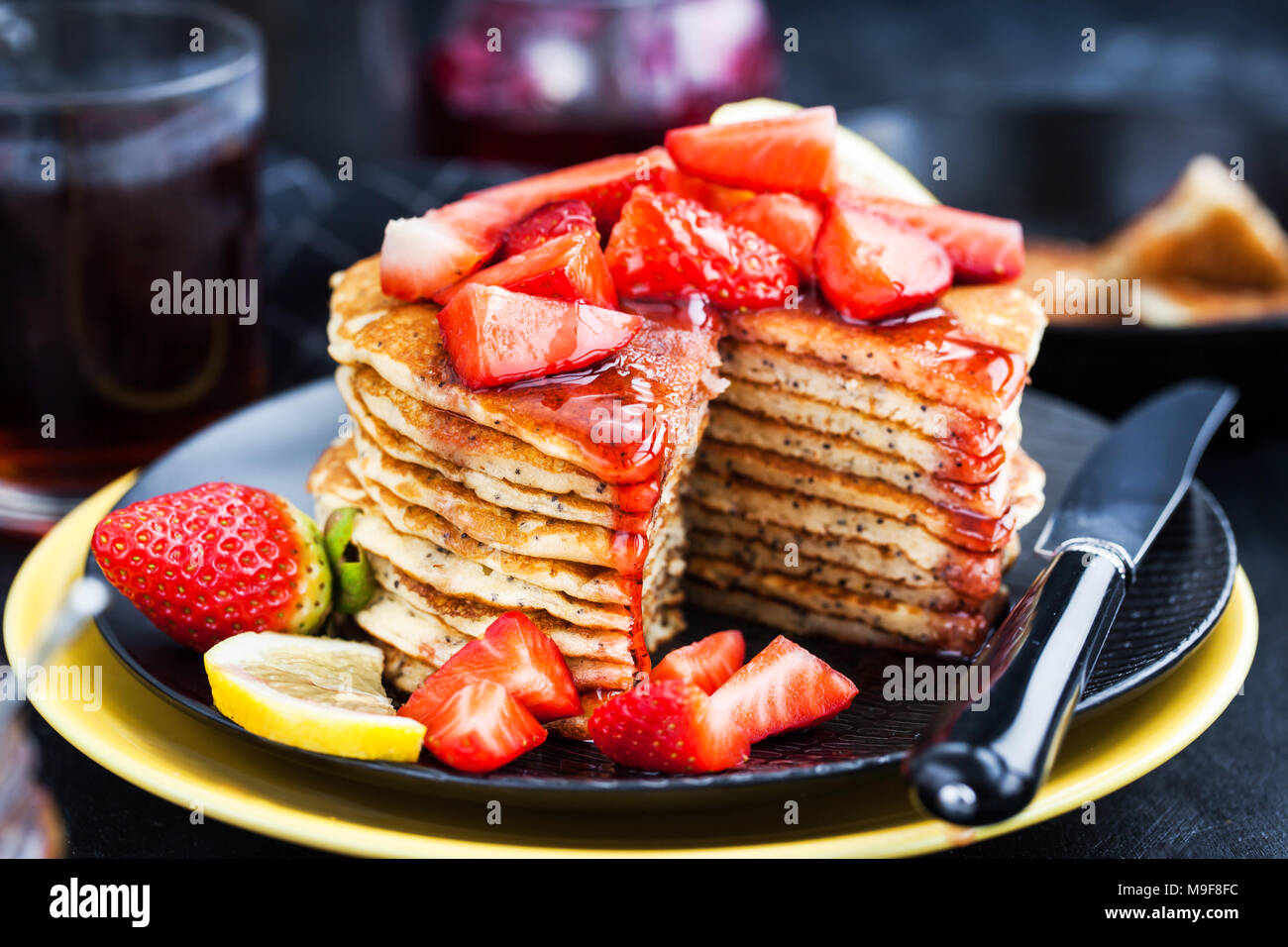 Stack of freshly prepared lemon poppy seed pancakes with fresh