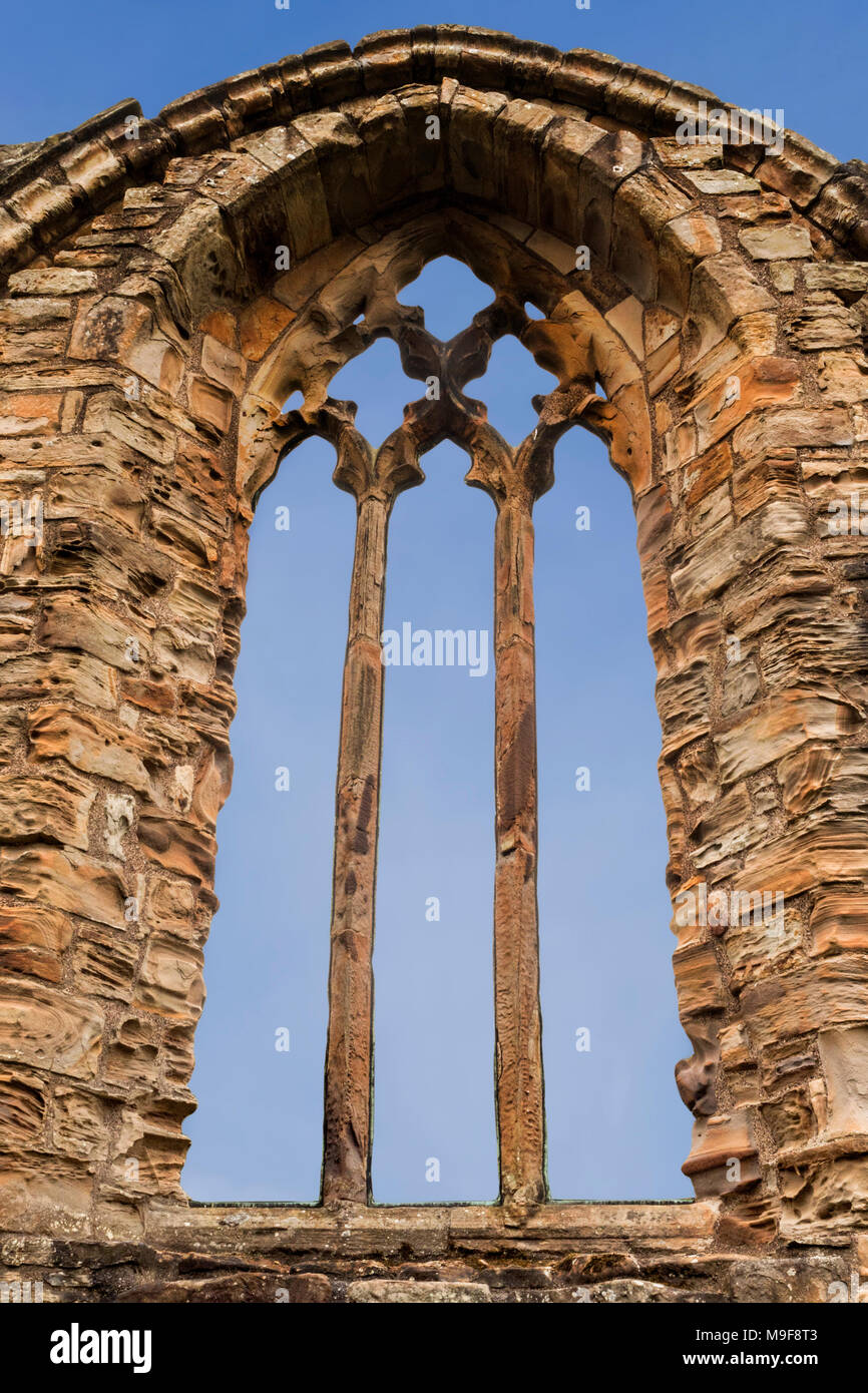 Triple lancet window with gothic quatrefoil tracery of carved sandstone at Finchale Priory in County Durham in the North East of England Stock Photo