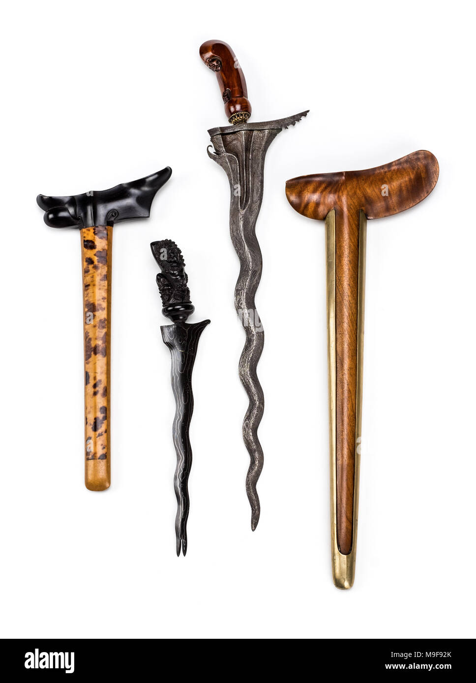 Kris daggers from Indonesia with wavy iron blades and complete with