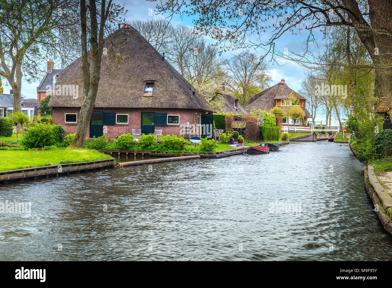 Real old dutch village with traditional houses and water canals on