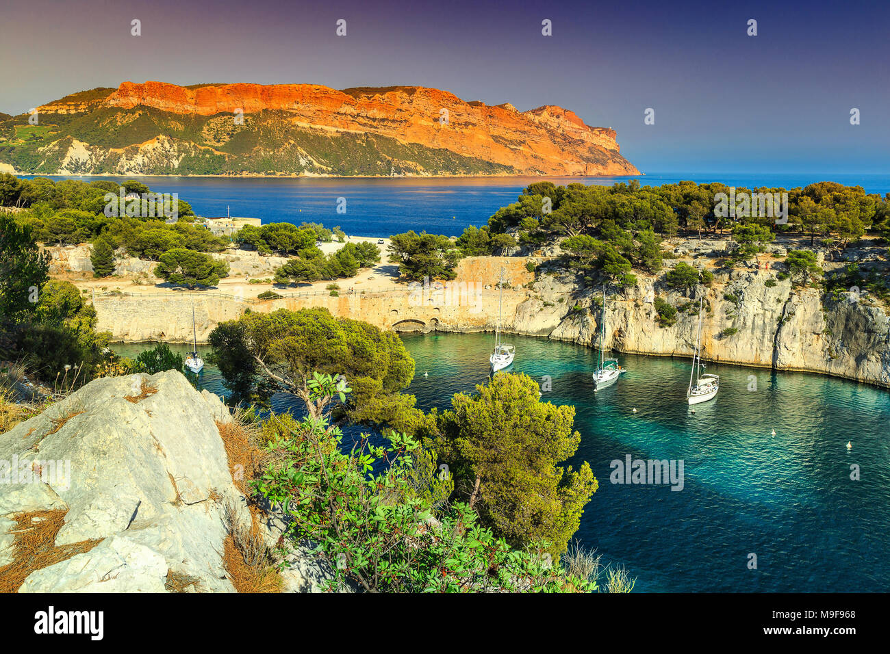 Amazing viewpoint on the cliffs, Calanques de Port Pin bay with yachts and sailing boats, Calanques National Park near Cassis fishing village, Provenc Stock Photo