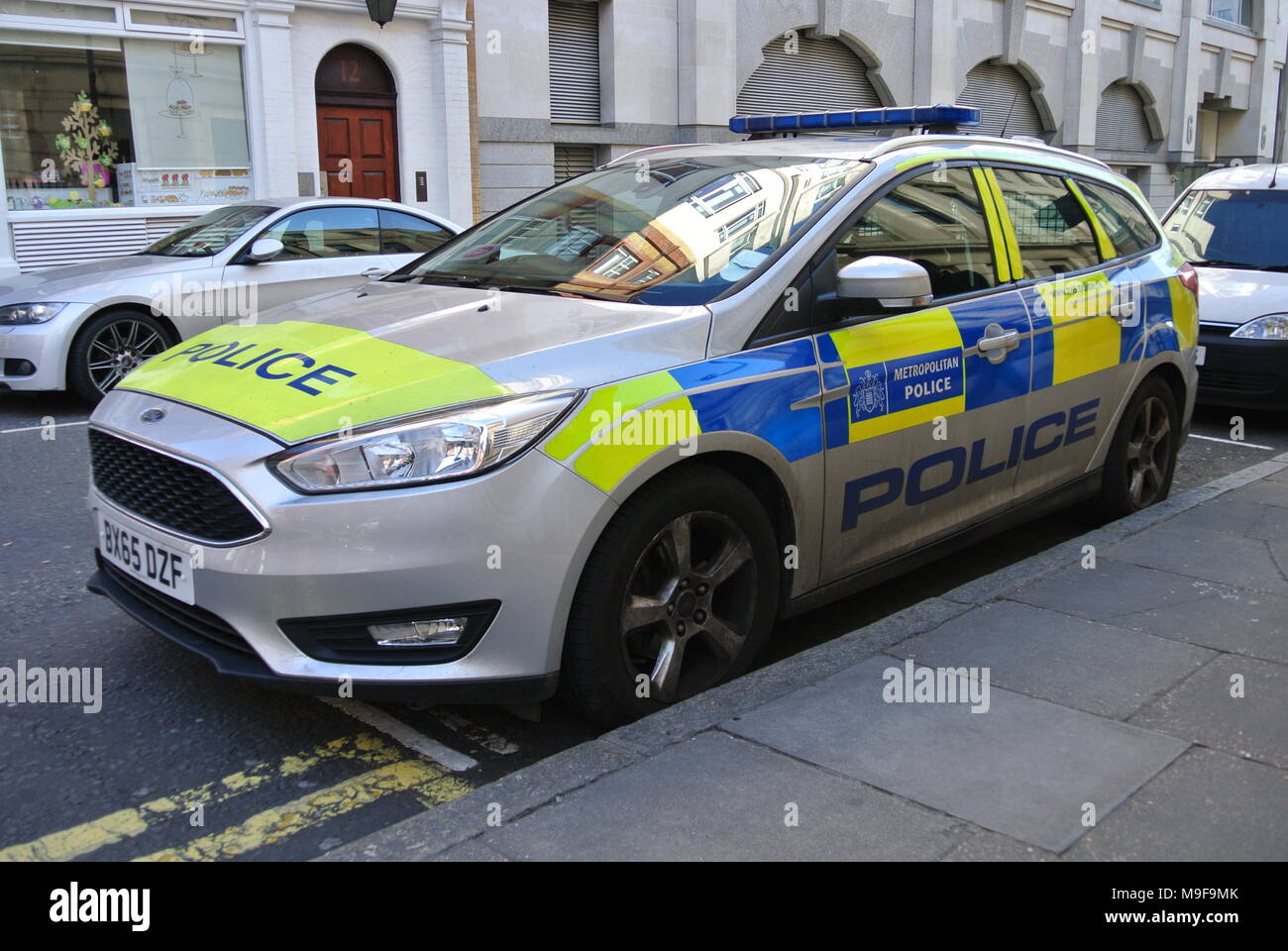 Metropolitan Police marked car parked next to a pavement, London
