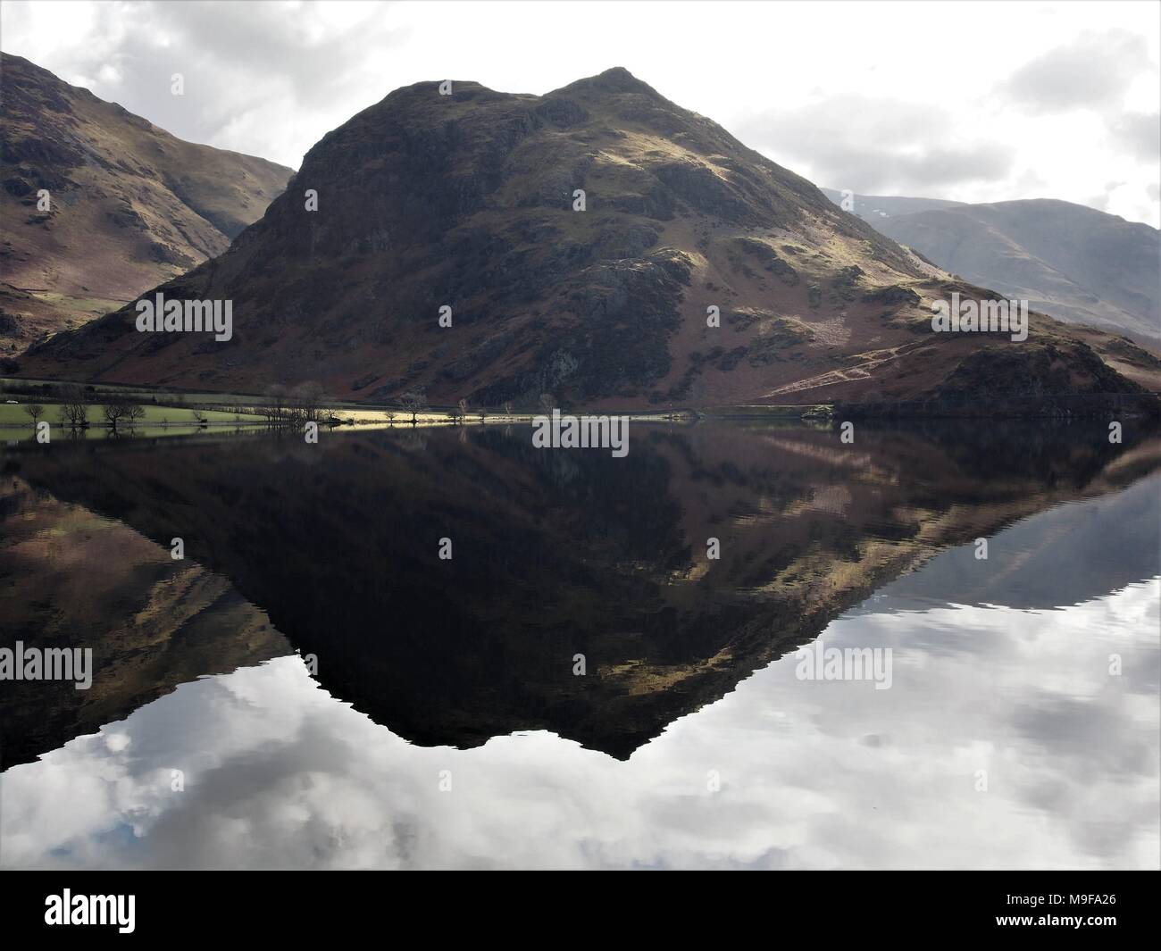 Rannerdale Knotts reflected in Crummock Water, Lake District National Park, Cumbria, United Kingdom Stock Photo
