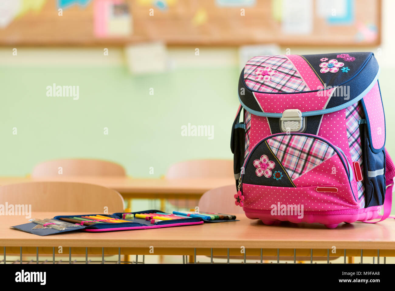Pink Girly School Bag And Pencil Case On A Desk In An Empty
